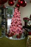 Judge Cribs pink tree with red ornments. Purchase this tree and recieve everything on it for free.
