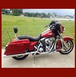 The 2010 Harley Davidson Street Glide sports an 18-inch front wheel with a lower profile. This bike has Rinehart Touring 4" slip-On Mufflers. A new feature added to the Street Glide is a chrome bracket that doubles as a visor and sits right above the low mounted license plate. The Street Glide comes with a recognizable black powder-coated powertrain with chrome covers. The bike also features black, slotted disc cast aluminum wheels. A lowered rear suspension gives this bike a sleek and attractive stance. The front of the bike consists of a bat-wing, fork-mounted fairing that has a smoke, mini wind deflector. Fairing-mount mirrors are also standard. The front fender of the Harley Davidson does not come with any trim. The fuel tank of the bike is low-profile, chrome, and features a console. The handlebar is stainless steel, and is classic touring. The seat is a one piece two-up Harley Street Glide seat. The injection-molded hard saddlebags come with color matched latches.