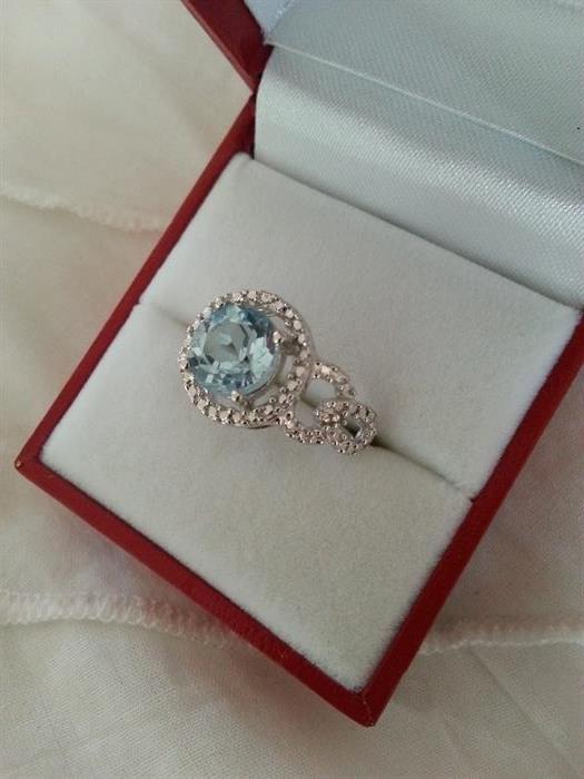Blue topaz and diamond dinner ring set in sterling silver. Size: 6.75