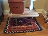 Turkish kilim rug, George Nelson-style table, English hat box.