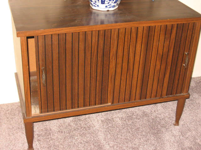 mid century wood cabinet with two sliding doors