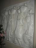 Wall art showing three women carrying urns. 48 inches wide, 42 inches tall.