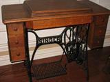 Antique Singer treadle sewing machine with oak cabinet and six drawers