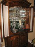 Bar hutch with three class shelves, opening bar counter, and two doors. 83 inches tall, 40 inches wide, 18 inches deep.