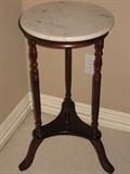 Round marble top plant stand. 28 inches tall, 14 inches across.