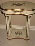 Beautiful occasional table with musical motifs. 22 inches long, 28 inches high, 14 inches deep.