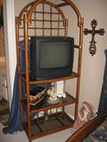 One of two Cane shelving units with three glass shelves