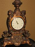 small cast clock. Battery-operated