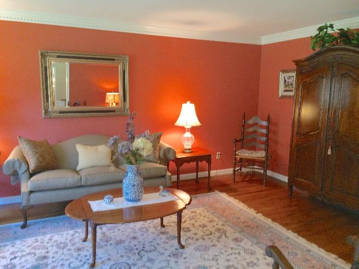 Beautiful living room sofa, armoire, rug, tables