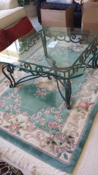 Room size oriental rug- excellent condition. Glass coffee table with green metal base.