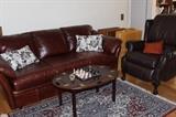 Leather couch and leather recliner, tea tray coffee table and onyx chess set.