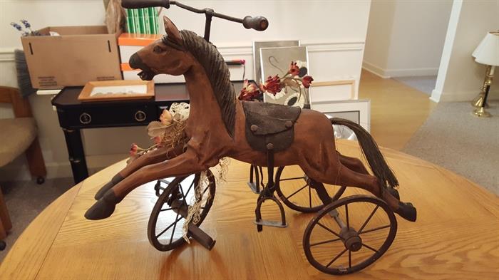 This is a hand carved, of wood, vintage, horse. Wheels move and rotate. 