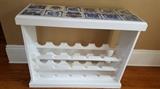 Custom made wine rack, porcelain, pharmaceutical tiles line the top, holds wine glasses and bottles
