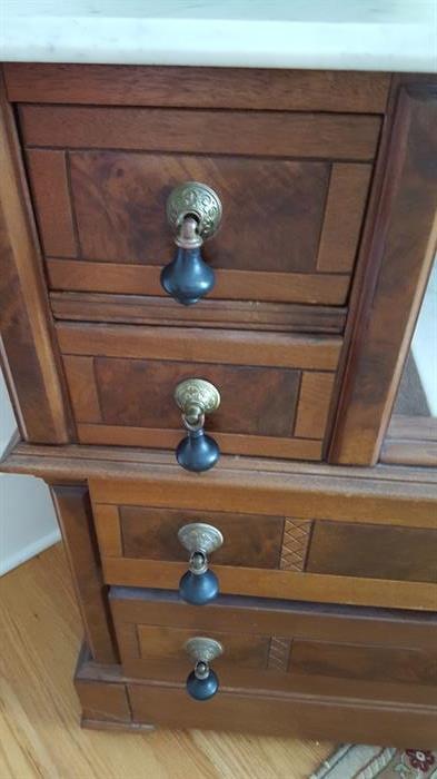 Teardrop handles on the Victorian, walnut, dresser with marble tops