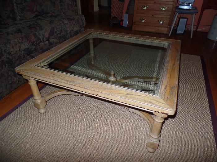 Wood and glass top coffee table. Rug not for sale.
