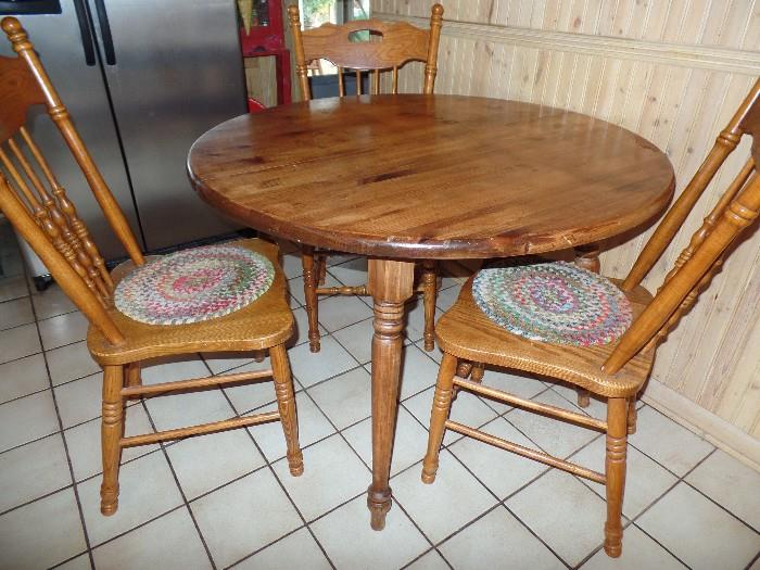 Vintage wood table with 4 chairs. Only 3 are showing