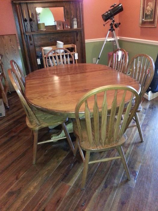 double pedestal oak table with six chairs and a 24 inch leaf (that is not in the table now)