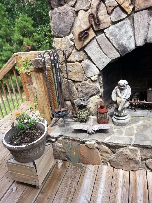 iron fireplace equipment, several unique lanterns, a cement angel, and other yard statuary