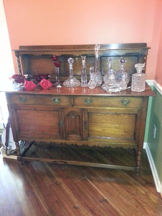 Beautiful Oak Sideboard, some lovely red glass pieces, several amazing lead crystal decanters and perfume bottles