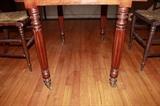 Three board top rests on reeded legs with original functioning castors.