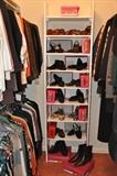 Closet filled with designer clothes and Vaneli shoes