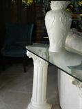 Glass top console table with vase.