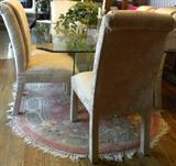 Close up of two of eight jacquard/brocade upholstered dining chairs.