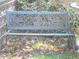 Angel motif verdigris finish garden bench.