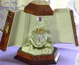Interior of fitted burled wood box with crystal perfume bottle.