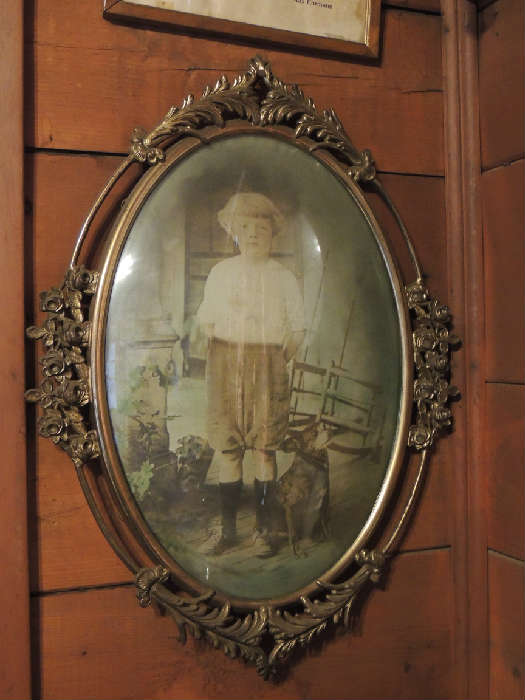 Huge antique Victorian brass curved glass rose/floral motif picture frame with portrait of young boy.