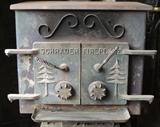 Exterior view-Schrader working cast iron fireplace, pine tree motif doors.