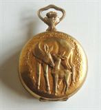 Swiss gold-plated jeweled movement pocket watch. Doe and fawn on one side, woman holding dove on the reverse.