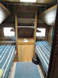 Camper/trailer interior, sleeps 3-4, with kitchenette (sink, cabinets, stove, refrigerator), dinette seating, bath and furnace. Priced to go!
