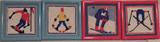 Four mini needlepoint pictures with downhill skiing motif.