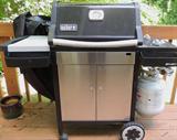 Weber gas grill (almost new) with cover.