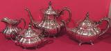 Lovely four piece tea set by Reed and Barton, in the "Hampton Court" pattern. The set includes coffee pot, tea pot, covered sugar bowl and creamer.