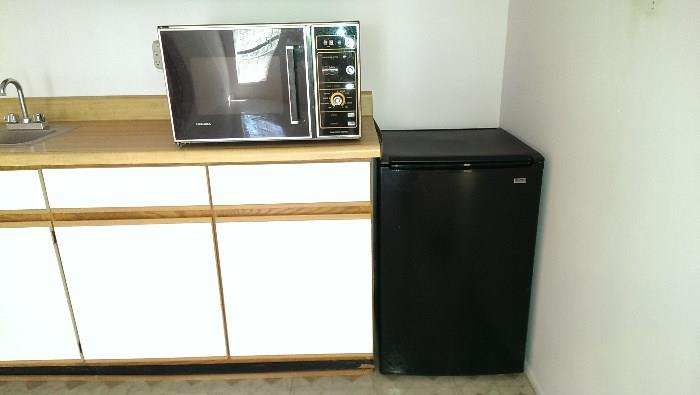 Microwave #2 of 3 and small fridge.