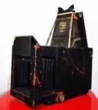 Item Description: A rare antique Reflex camera 1898 and several model improvements of the Reflex camera with variations were made through 1915 with the closing of the company. The original Patented Reflex camera was made in a 4 x 5 and 5 x 7 inch sizes. The cameras were constructed of wood with leather covering. The camera featured a fast focal plane shutter providing of exposures speeds from 1 to 1/1000 of a second. the image was viewed in the collapsible hood by a hinged internal mirror which reflects the full sized image on to the ground glass up to the instant of exposure so that the image can be proper framed and focused. There is also a ground glass in the rear of the camera for focusing in the usual way when the camera is on a tripod.