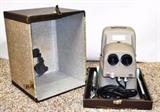 Item Description: A cool vintage Stereo Vivid Deluxe Model 716 3D slide projector, from Three Dimension Company by Bell and Howell with hard case and GE Projection bulb PH/750T12-5-120V in original packaging.