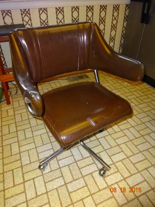 A leather upholstered swivel chair
