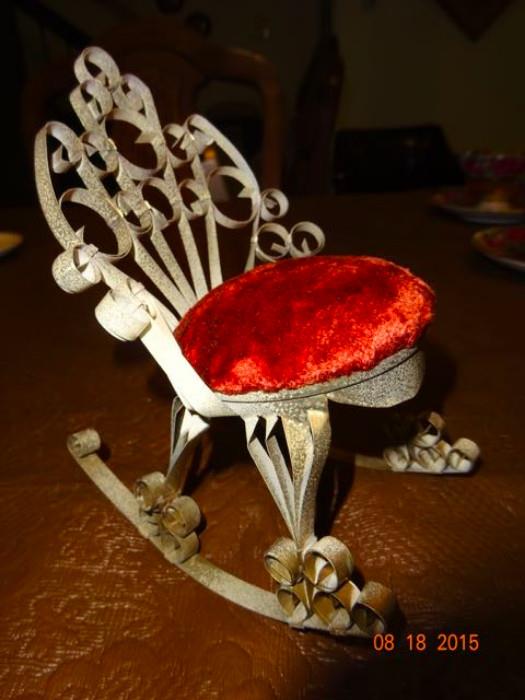 A red cushioned rocking chair