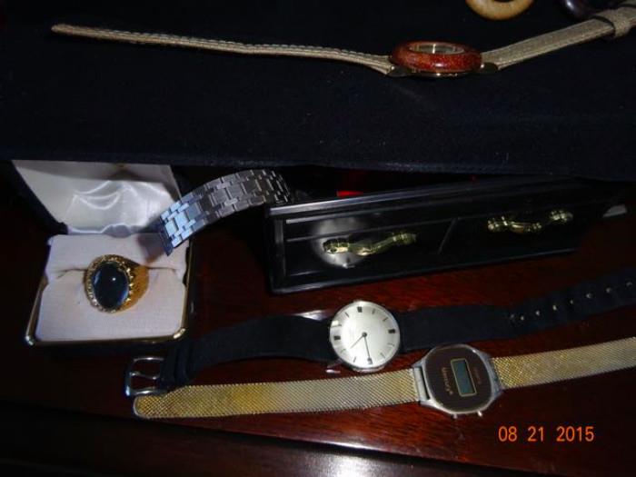 A pair of watches and a class ring