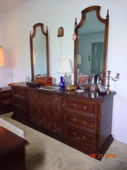 A dresser with two mirrors.