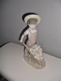 Lladro figurine of boy pushing cart of flowers