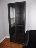 One of a pair of black cabinets with glass inserts from Ikea--center press to open doors