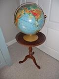 Round pedestal side table by Bombay Co. and a world globe on stand