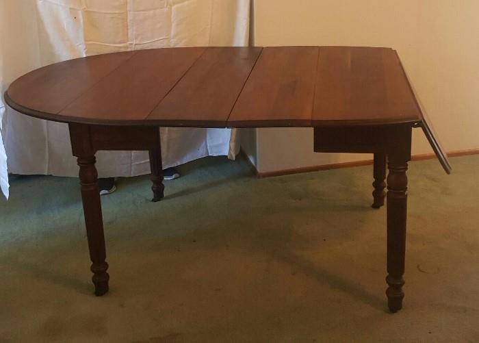 1860s mahogany Pembroke drop leaf table with 2 leaves. Original primitive iron hardware supports the drops and the table is on original brass casters. Not a scratch on this lovely table.