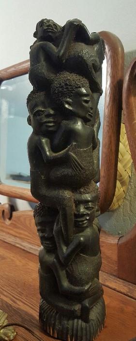 African Maconde Tree of Life hand carved ebony sculpture from Kenya. Parents embracing at he base hold up several children carved into the truck clinging to the tree. Beautifully detailed 16" piece. There is also a second more intricate one.