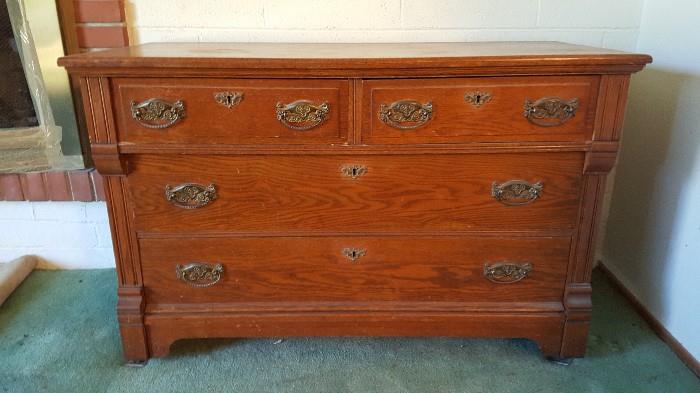 MId to late 1800 tiger oak dresser. Often used in a bathroom or dressing room. Ornate heavy piece.