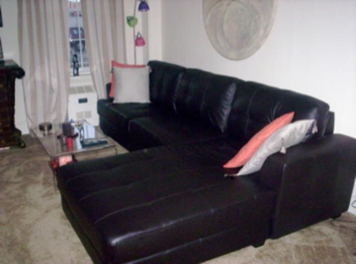 COUCH WITH RETURN LESS THAN YEAR OLD. PRISTINE CONDITION.  LUCITE COFFEE TABLE IN FRONT OF COUCH.  FLOOR LAMP CORNER